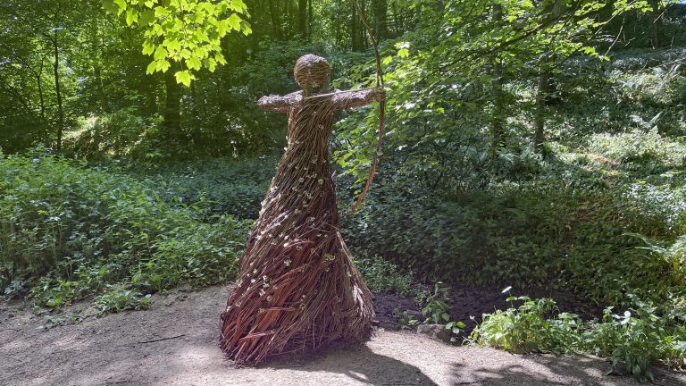 Spirit of the Medieval Huntress a statue by Anna Cross constructed from Willow on a hand forged steel frame