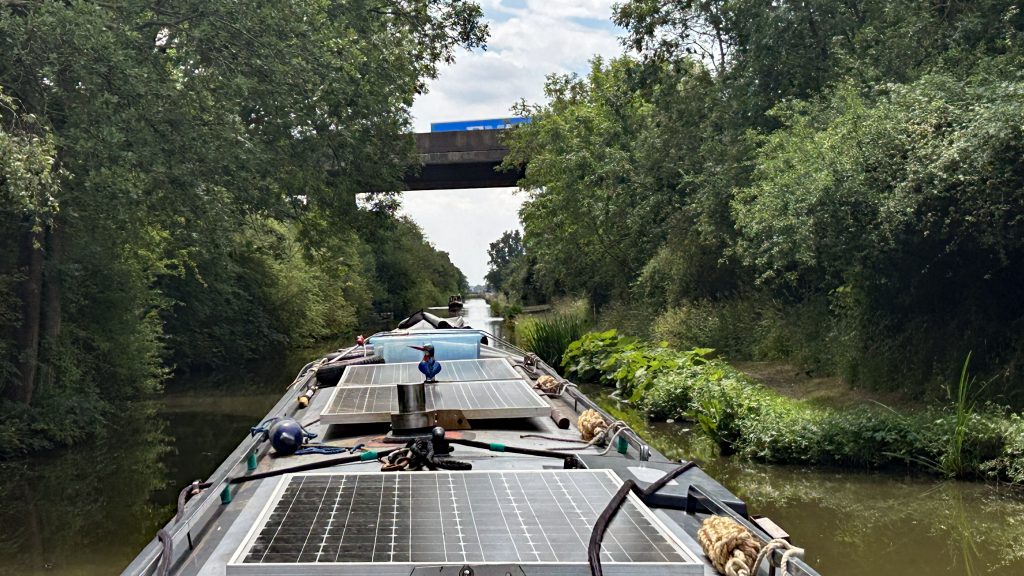 NB Fantasma cruises quietly under the M6 Motorway