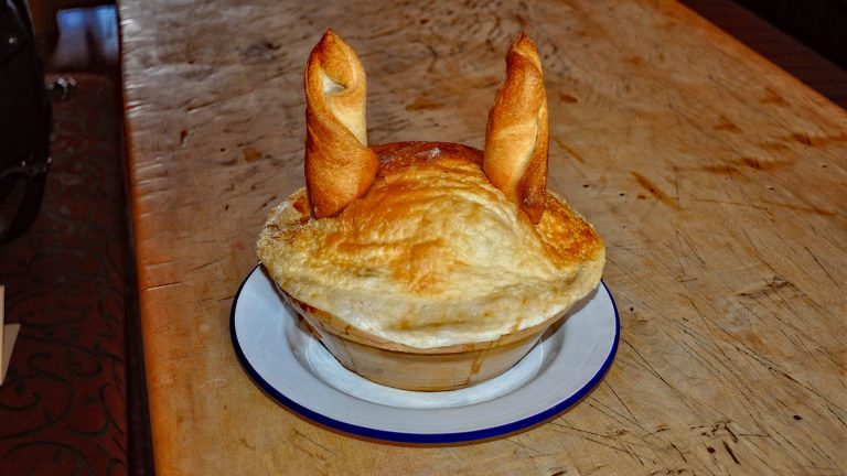 A photo of a Desperate Dan Cow Pie complete with pastry cow horns